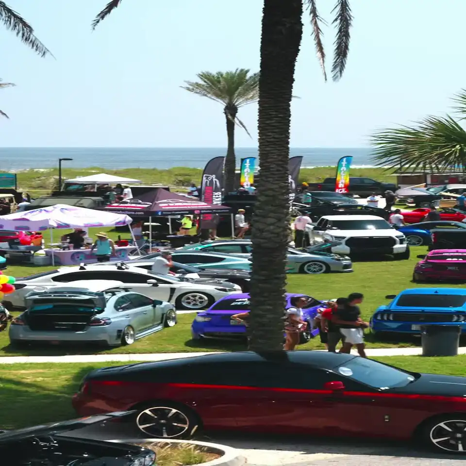 Show field and tents with the ocean behind