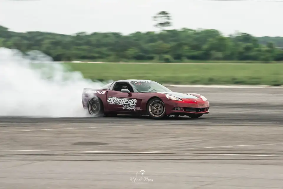 Red drift car mid-slide