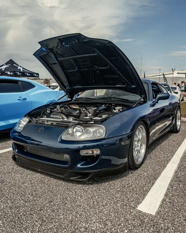 Blue RX-7 with the hood up