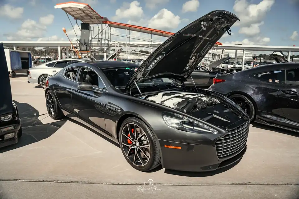 Grey Aston Martin with the hood up