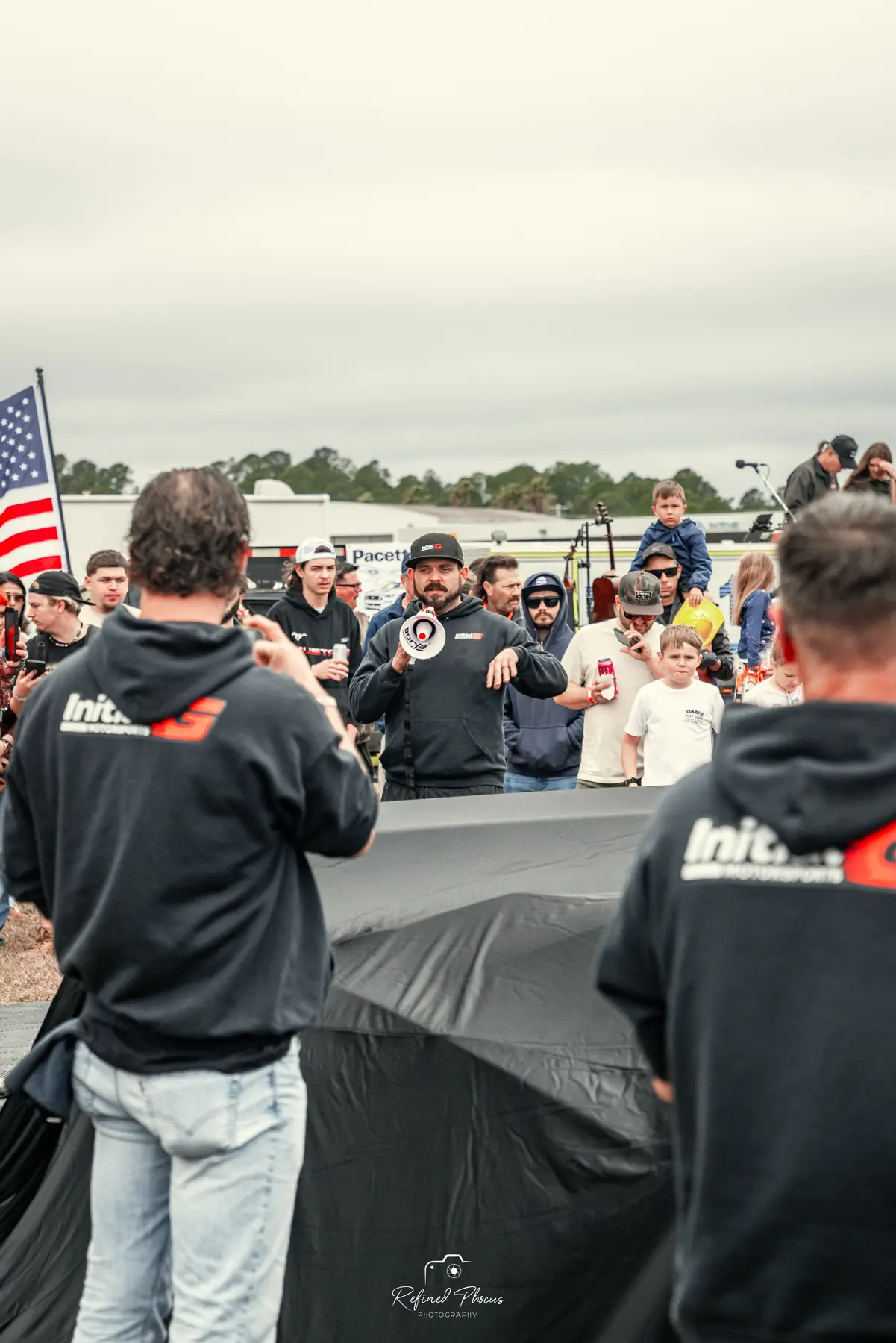 Unveiling a covered car in front of the crowd