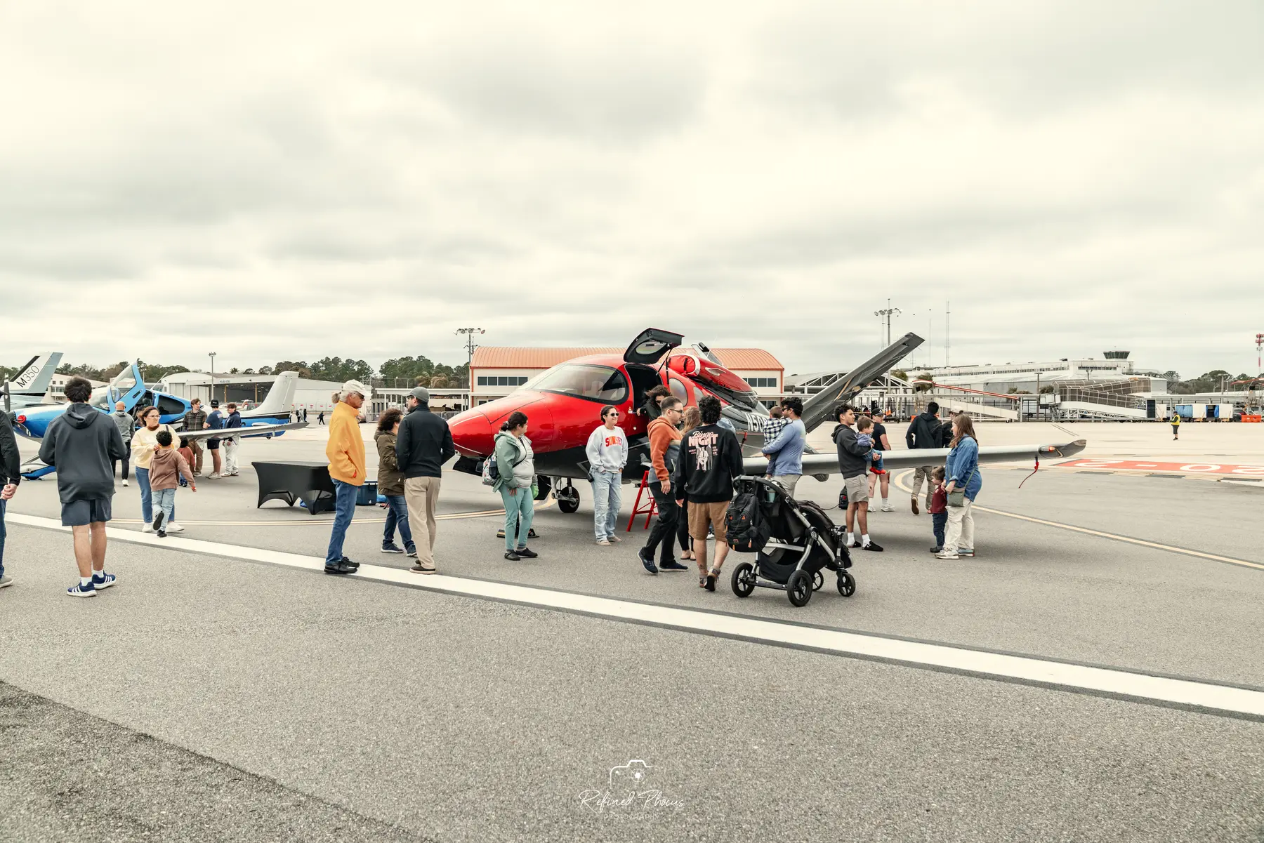 Spectators walking the runway between the aircraft