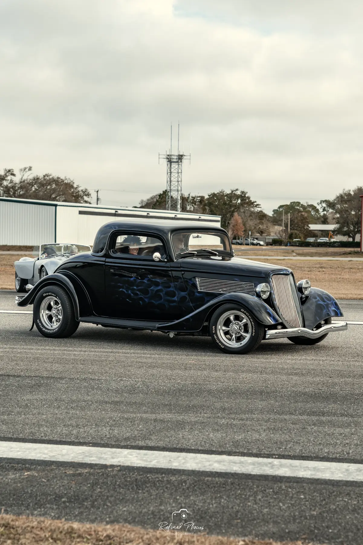 Black hot rod on the runway