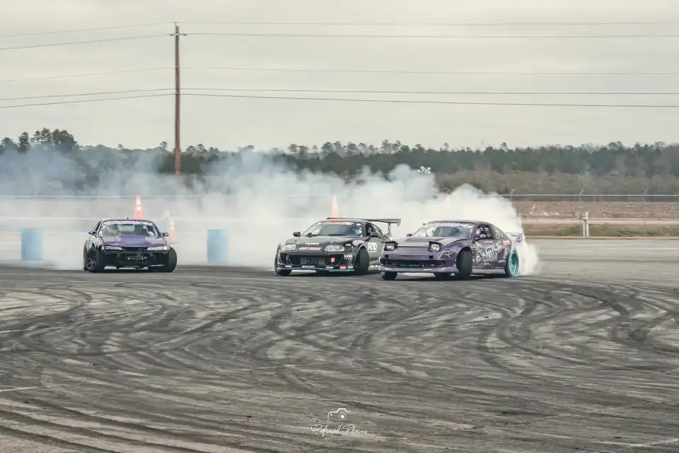 Three cars drifting in tandem